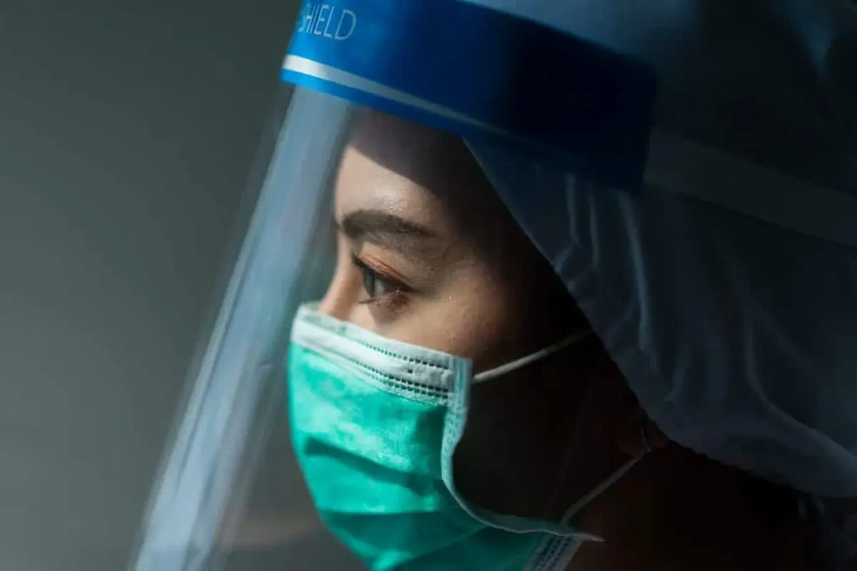 Healthcare worker wearing face shield and mask