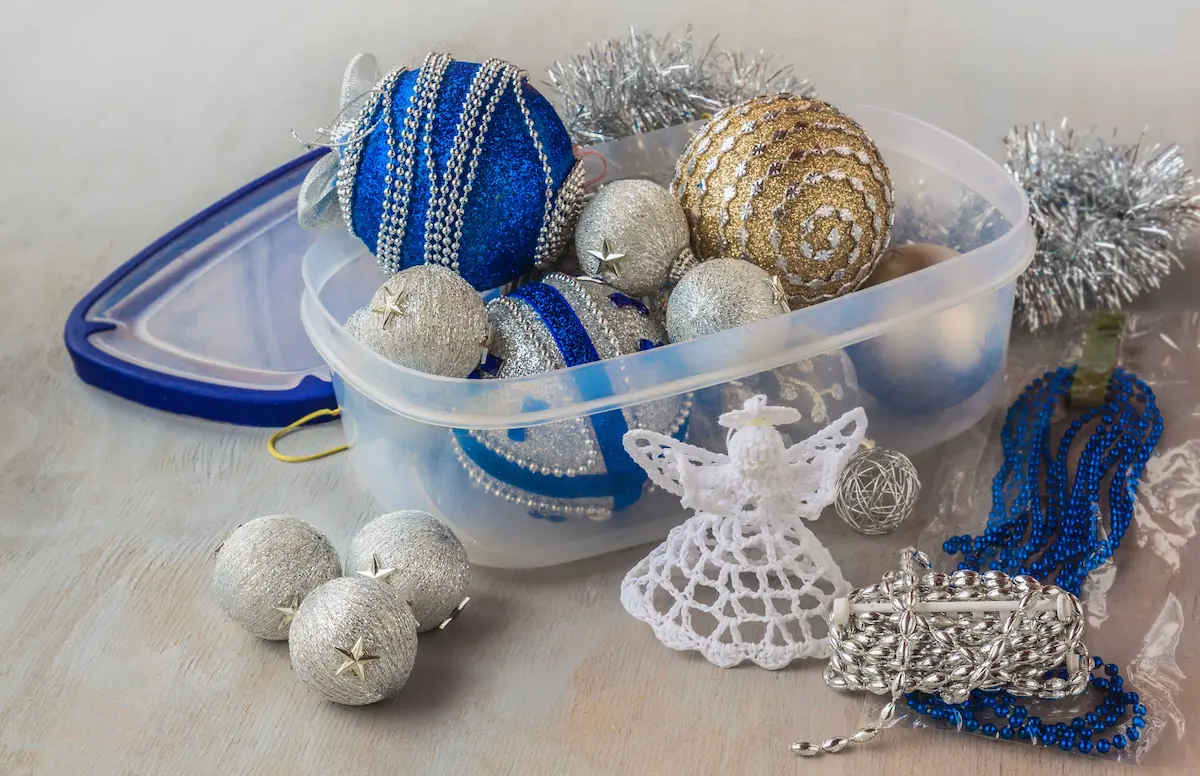 Plastic storage container filled with Christmas ornaments and decorations