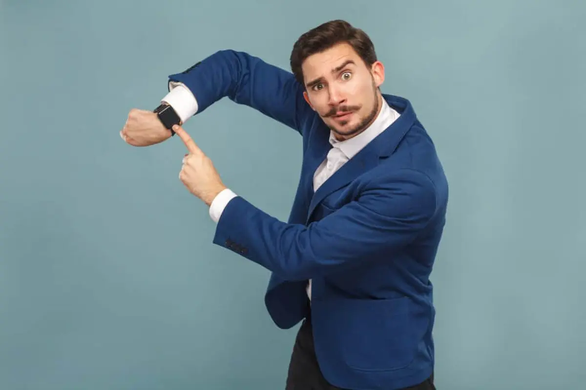 Man pointing to watch