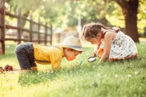 shutterstock 1461003068 Cute,Adorable,Caucasian,Girl,And,Boy,Looking,At,Plants,Grass