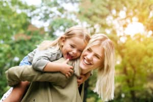 shutterstock 535152550 Cute,Young,Daughter,On,A,Piggy,Back,Ride,With,Her