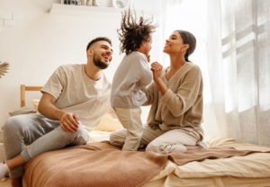 shutterstock 1837072894 Happy,Family,Multiethnic,Mother,,Father,And,Son,Laughing,,Playing,and,Jumping