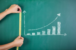 shutterstock 144543284 Closeup,Of,Woman's,Hands,Measuring,Bar,Graph,With,Tape,On