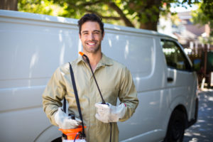 shutterstock 402477157 Portrait,Of,Smiling,Worker,With,Pesticide,Sprayer,While,Standing,By