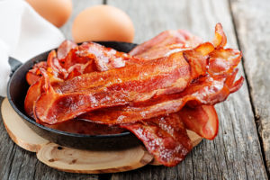 shutterstock 1046058229 Hot,Fried,Bacon,Pieces,In,A,Cast,Iron,Skillet.top,View