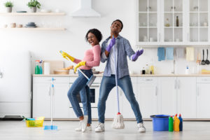 shutterstock 1922827772 Joyful,Black,Loving,Couple,Singing,Songs,While,Cleaning,Kitchen,,Using