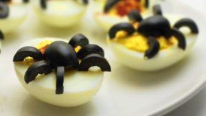 shutterstock 1194881368 Delived,Eggs,Topped,With,Olive,Spiders,On,A,White,Plate.