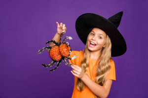 shutterstock 1527262307 Photo,Of,Pretty,Little,Witch,Lady,Holding,Big,Toy,Spider