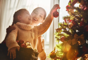 shutterstock 519972937 Merry,Christmas,And,Happy,Holidays!,Mom,And,Daughter,Decorate,The