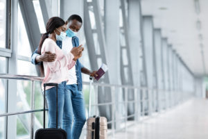 shutterstock 1793719354 Booking,Hotel,Online.,Black,Couple,In,Medical,Masks,Using,Smartphone