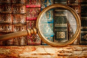 shutterstock 383151472 Ancient,Old,Books,And,Magnifying,Glass