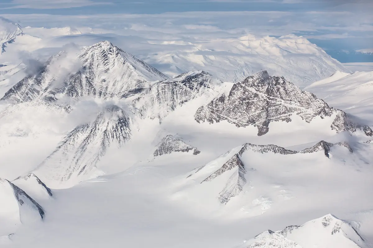 Aerial view of snow-covered mountains and glaciers in a frozen landscape