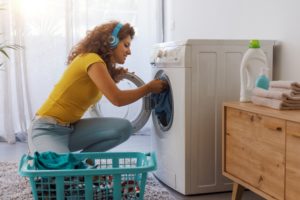 vacation chores Happy,Young,Woman,Doing,Laundry,At,Home,,She,Is,Loading