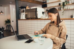 coffee spider Young,Woman,Freelancer,Working,Online,Using,Her,Laptop,,Drinking,Coffee