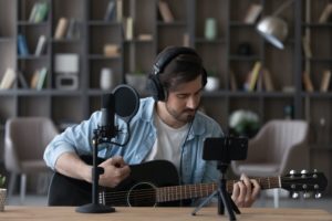 instagram cricket Man,In,Headphones,Playing,Acoustic,Guitar,,Recording,Video,On,Smartphone