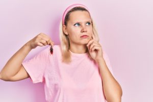 pest phrases cover Beautiful,Caucasian,Blonde,Woman,Holding,Cockroach,Serious,Face,Thinking,About