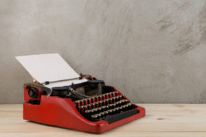 childrens click clack Vintage,Typewriter,On,The,Table,With,Blank,Paper,On,Wooden