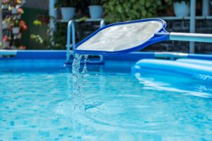 pool pests cover Swimming,Pool,Cleaning,Net,With,Water,Droplets,In,The,Background