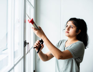forgotten place prevent Woman,Using,A,Silicone,Gun,To,Repair,A,Window