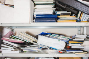 forgotten places boxes and paper Declutter,Concept,-,Lots,Of,Books,,Papers,,Boxes,On,Shelf