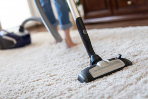thanksgiving clean up Young,Woman,Using,A,Vacuum,Cleaner,While,Cleaning,Carpet,In