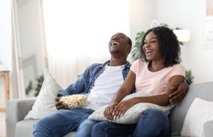 sitcom 2 cover Laughing,African,American,Family,Of,Two,Watching,Movie,Together,At