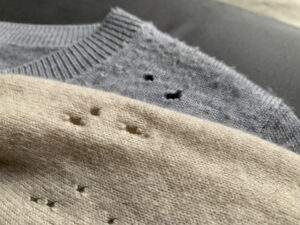 return signs fabric Two,Expensive,Cashmere,Sweaters,With,Holes,And,Damaged,,Caused,By