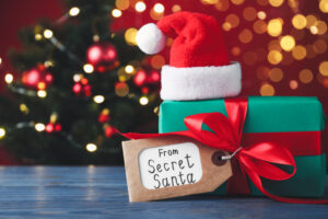 what if santa cover Present,From,Secret,Santa,On,Blue,Wooden,Table,Against,Blurred