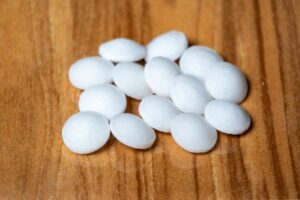clothes moth moth balls Naphthalene,Balls,Isolated,On,Wooden,Background.,It,Is,Also,Known