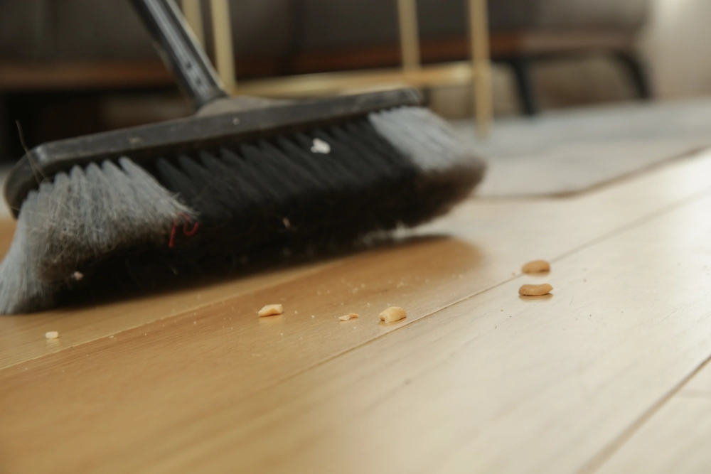 sweeping up crumbs with a broom